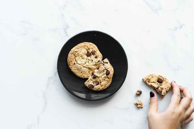 two cookies on black ceramic plate