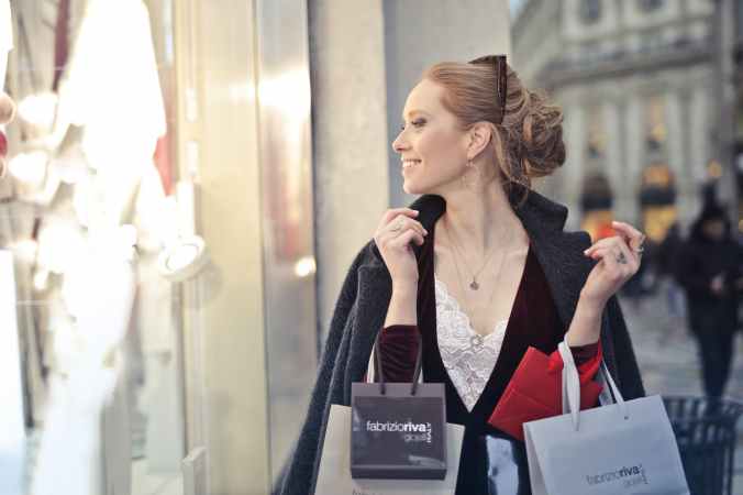 photo of a woman holding shopping bags