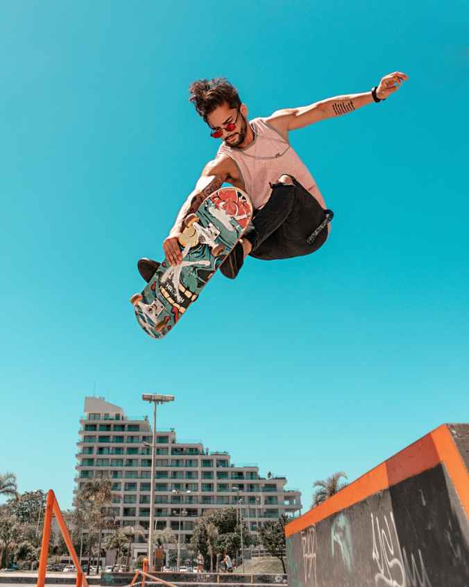 low angle shot of a man on a skateboard in mid air